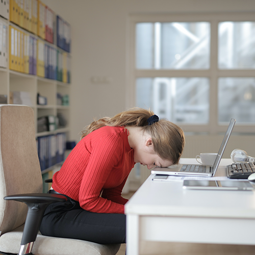 Woman with head on desk