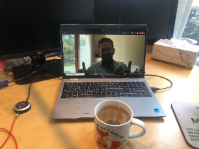 Person chatting over zoom with coffee