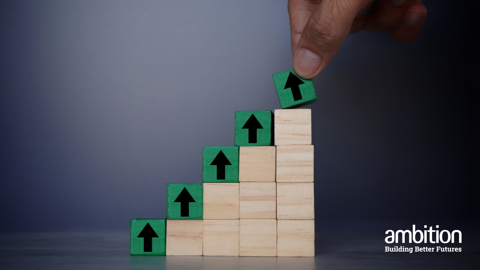 Stacked blocks in five columns. There is a green block on the top of each column and a black arrow pointing upwards indicating increasing heights from left to right