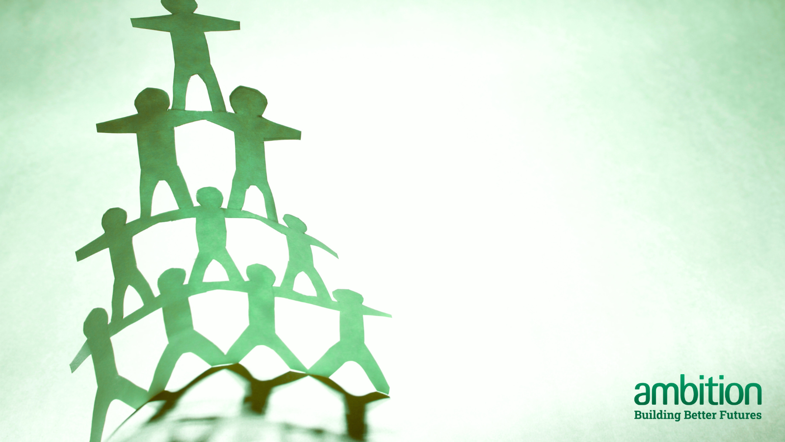 A green tower made up of 10 paper men against a lighter green background